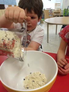 pouring in the blueberry muffin mix