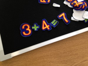 using felt numbers to create a math sentence 