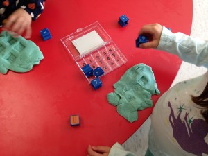 using stamps in the playdough