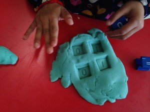 stamping numbers in to playdough