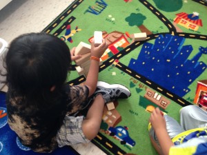 Fine motor/math/science: stacking and un-stacking my tower of blocks.  What shapes can you see?