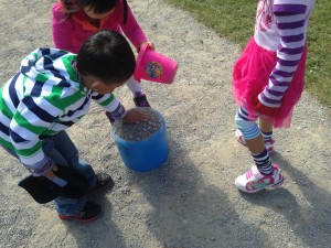 Working together to build a rock tower outside 